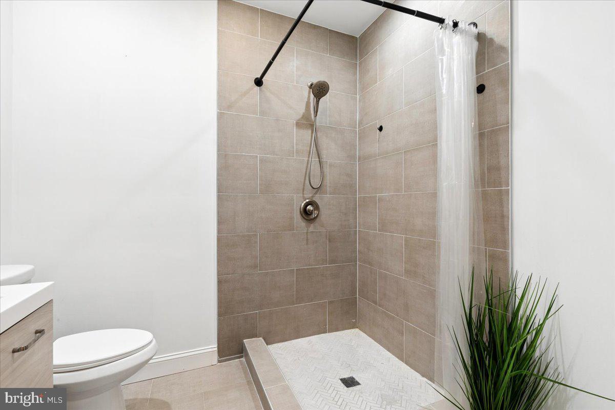 3249 Arundel On The Bay Road Annapolis, MD 21403 - Photo 69 of 88 a bathroom with a shower a toilet and a sink