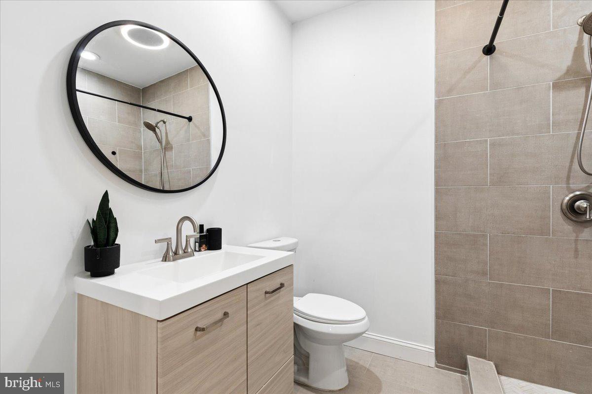 3249 Arundel On The Bay Road Annapolis, MD 21403 - Photo 81 of 88 a bathroom with a sink a mirror a toilet and a mirror