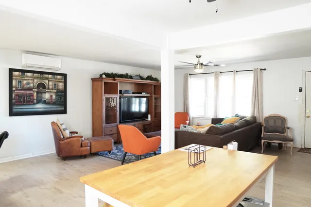 a bedroom with furniture and wooden floor