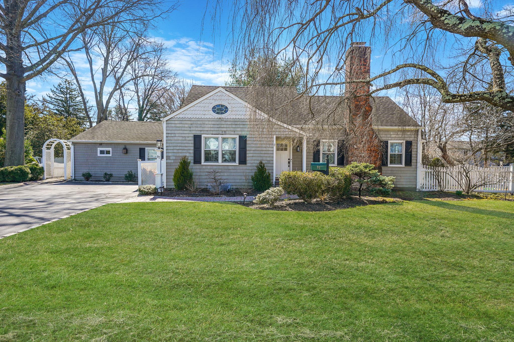 97 Elliman Place Syosset, NY 11791 - Photo 1 of 1 View of front of home featuring a front lawn, driveway, a shingled roof, and fence