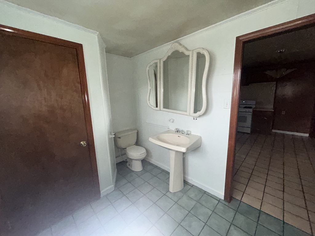 69 Mott Street Fall River, MA 02721 - Photo 11 of 31 a bathroom with a toilet sink and mirror