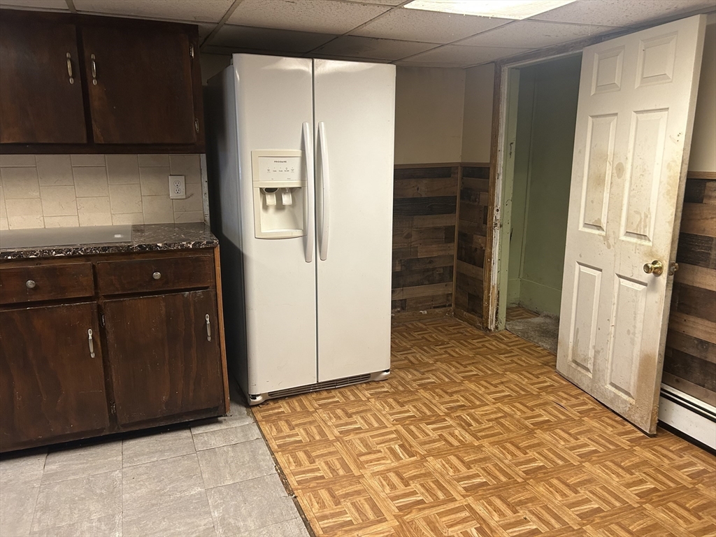 69 Mott Street Fall River, MA 02721 - Photo 28 of 31 a kitchen with a refrigerator stove and cabinets