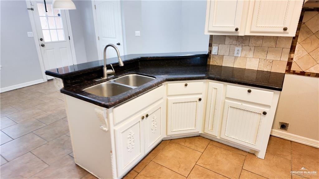 3000 Linva Avenue Edinburg, TX 78541 - Photo 4 of 12 a kitchen with granite countertop white cabinets and sink