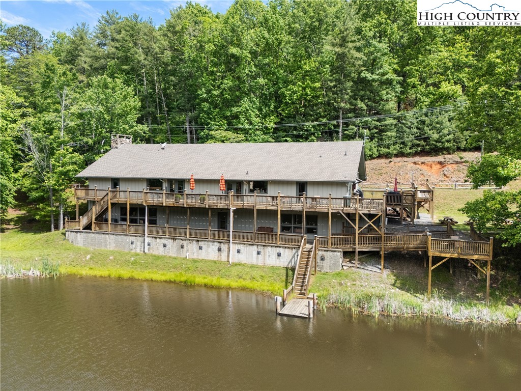 212 Saddle Lane, Unit 29 Deep Gap, NC 28618 - Photo 23 of 35 an aerial view of a house with swimming pool and large trees