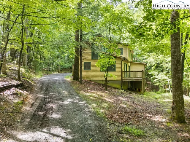a view of a house with large trees