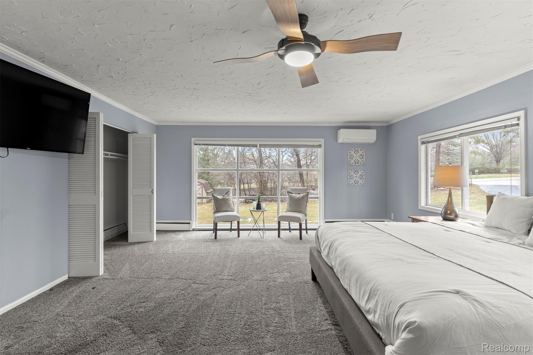 45401 West 9 Mile Road Novi, MI 48374 - Photo 26 of 67 Bedroom featuring carpet, ceiling fan, multiple windows, ornamental molding, and a textured ceiling