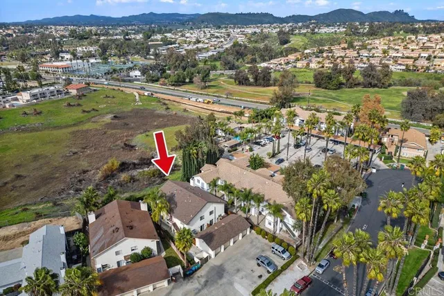 an aerial view of residential houses with outdoor space and river