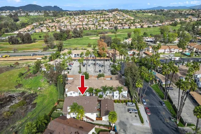 an aerial view of residential houses with outdoor space and street view