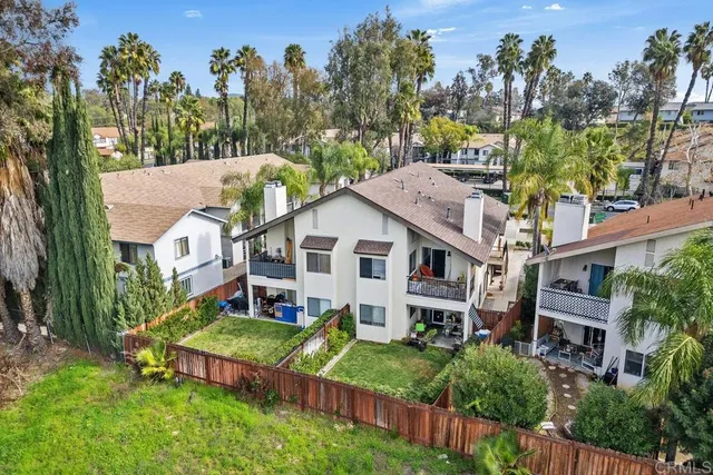 a aerial view of a house next to a big yard and large trees