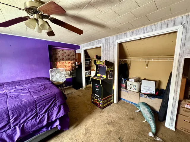 a bedroom with a bed and a mirror