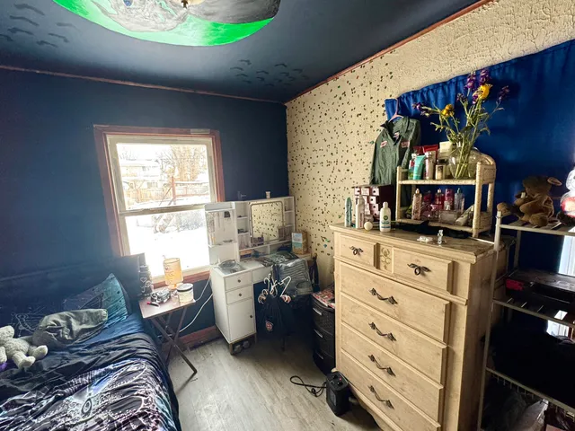 a bedroom with a bed and a window