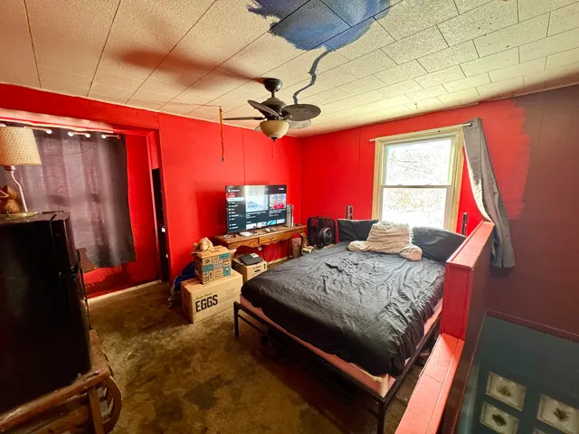 a bed room with a bed and a window