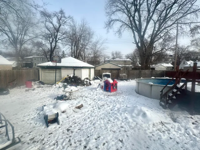 a table and chairs sitting in backyard of house