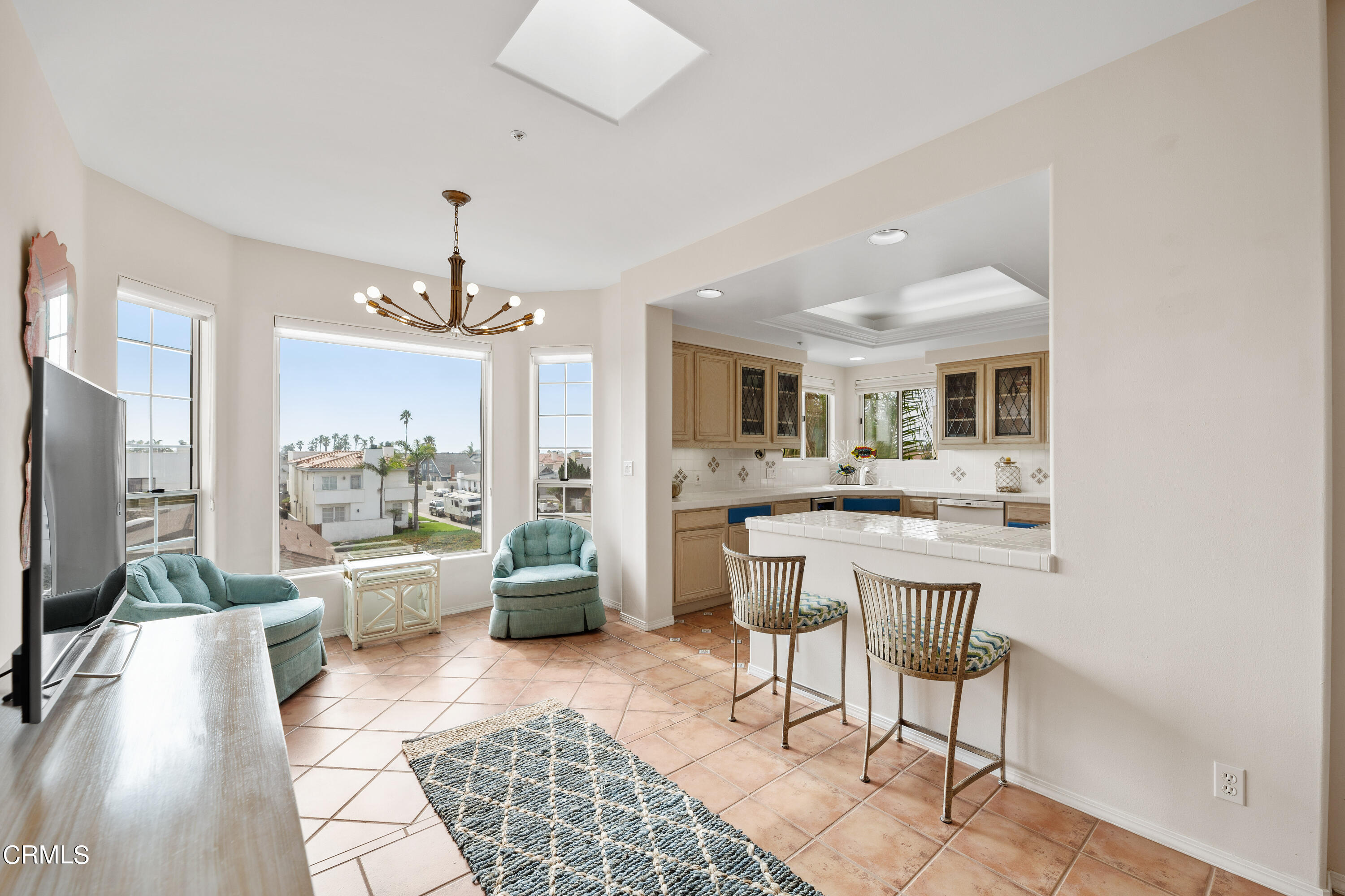 1316 Mandalay Beach Road Oxnard, CA 93035 - Photo 12 of 33 a living room with furniture a chandelier and a flat screen tv