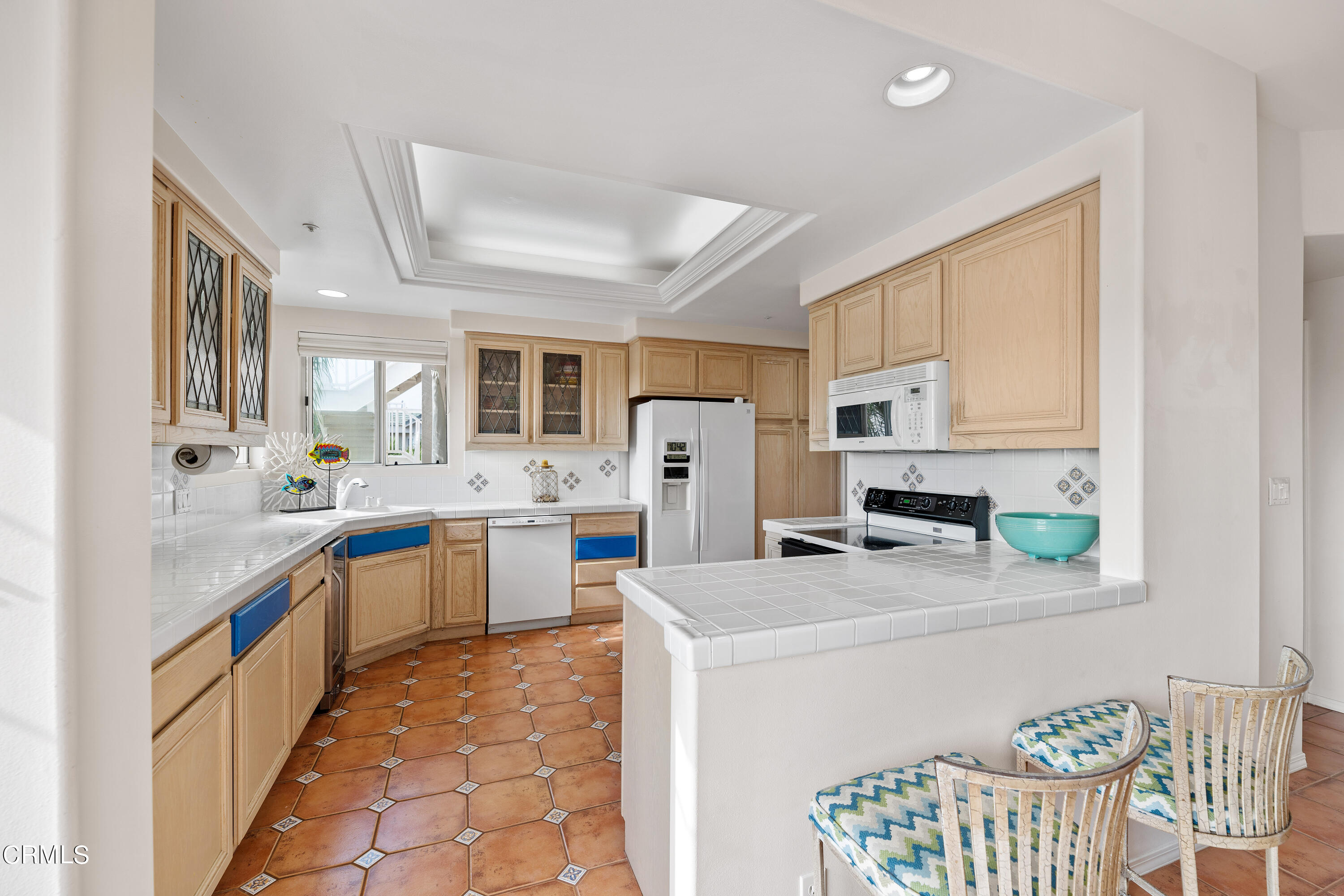 1316 Mandalay Beach Road Oxnard, CA 93035 - Photo 14 of 33 a kitchen with stainless steel appliances a refrigerator sink and white cabinets