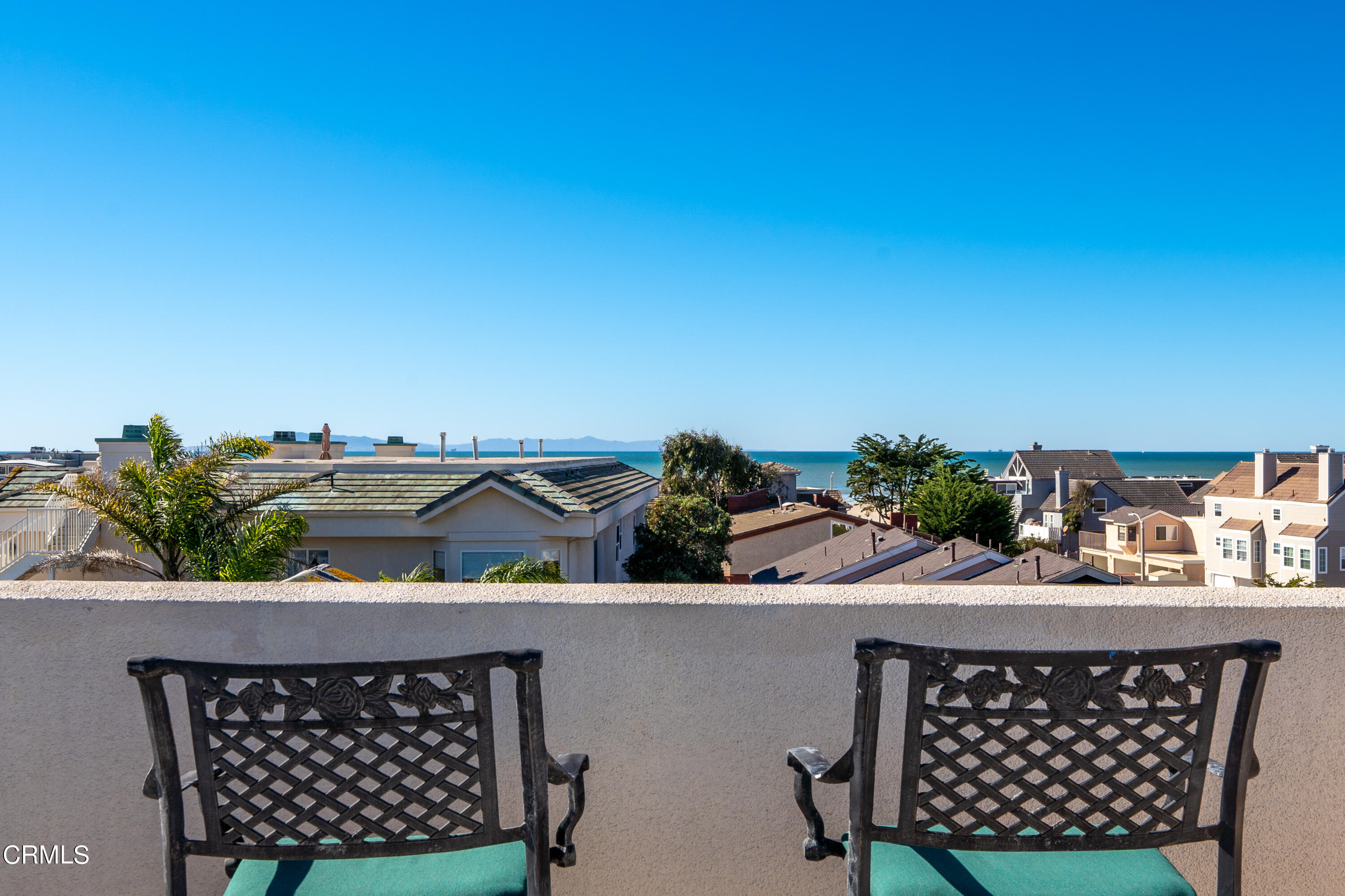 1316 Mandalay Beach Road Oxnard, CA 93035 - Photo 4 of 33 a table with some potted plants and a chair