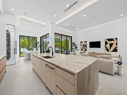 a large white kitchen with a large window