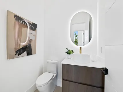 a bathroom with a toilet a sink and mirror