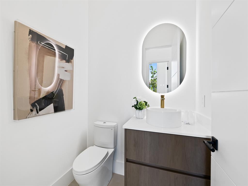 1717 Northeast 17th Terrace Fort Lauderdale, FL 33305 - Photo 20 of 40 a bathroom with a toilet a sink and mirror