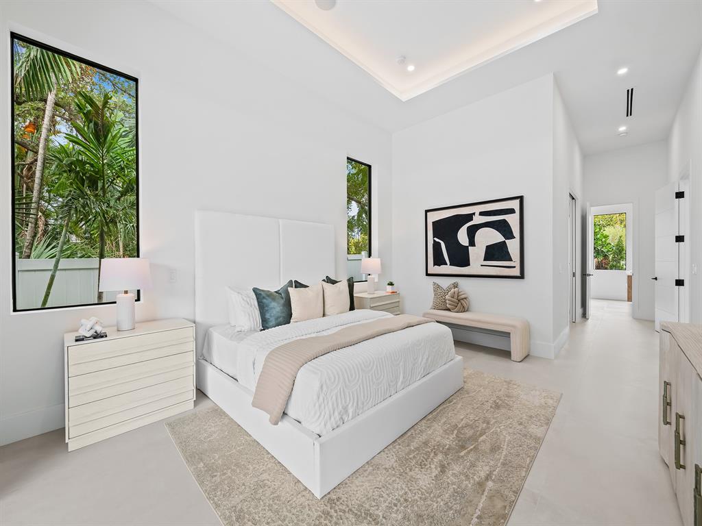 1717 Northeast 17th Terrace Fort Lauderdale, FL 33305 - Photo 22 of 40 a bedroom with a large bed and a couch