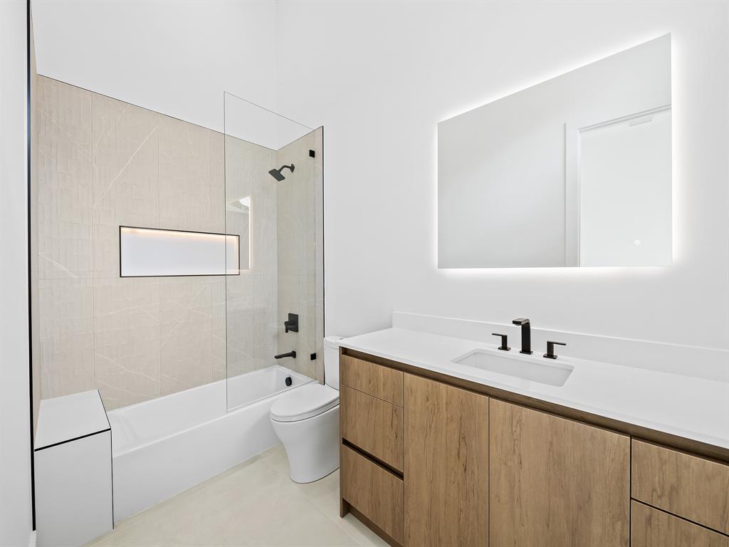 1717 Northeast 17th Terrace Fort Lauderdale, FL 33305 - Photo 37 of 40 a bathroom with a tub a sink and mirror