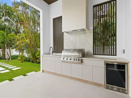 a kitchen with a stove and a white sink