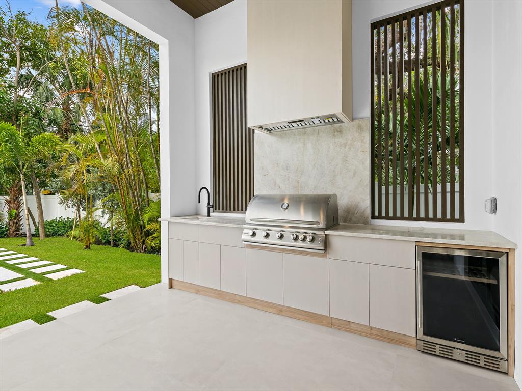 1717 Northeast 17th Terrace Fort Lauderdale, FL 33305 - Photo 6 of 40 a kitchen with a stove and a white sink