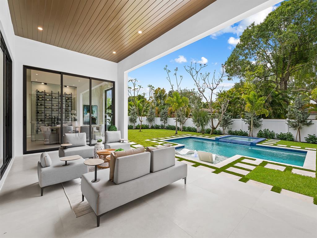 1717 Northeast 17th Terrace Fort Lauderdale, FL 33305 - Photo 7 of 40 a view of swimming pool with outdoor seating and a garden
