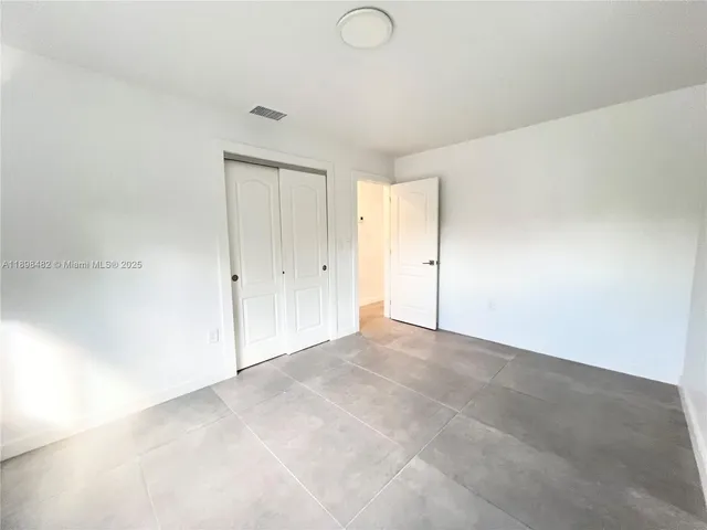 a white car parked in front of a house