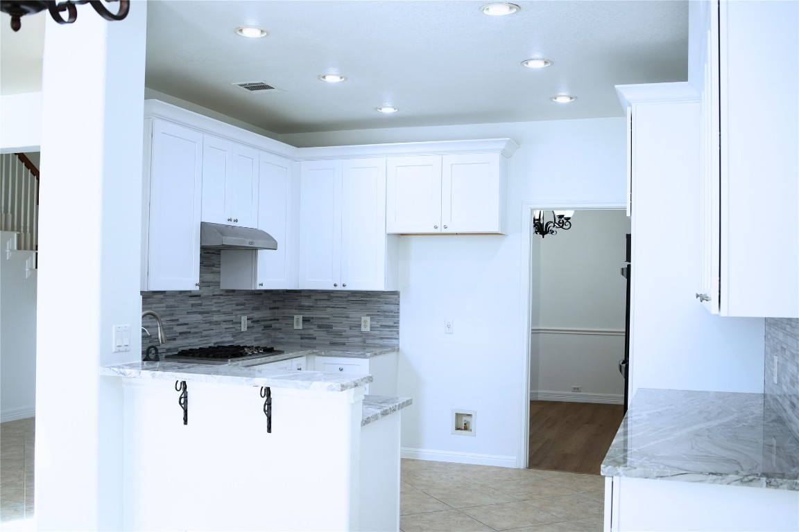 9501 Aire Libre Drive Austin, TX 78726 - Photo 14 of 38 a kitchen with a sink a refrigerator and cabinets