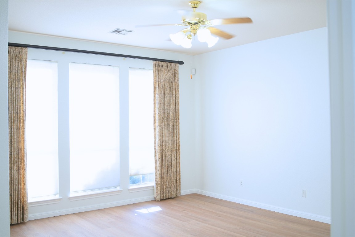 9501 Aire Libre Drive Austin, TX 78726 - Photo 16 of 38 an empty room with a window and a fan
