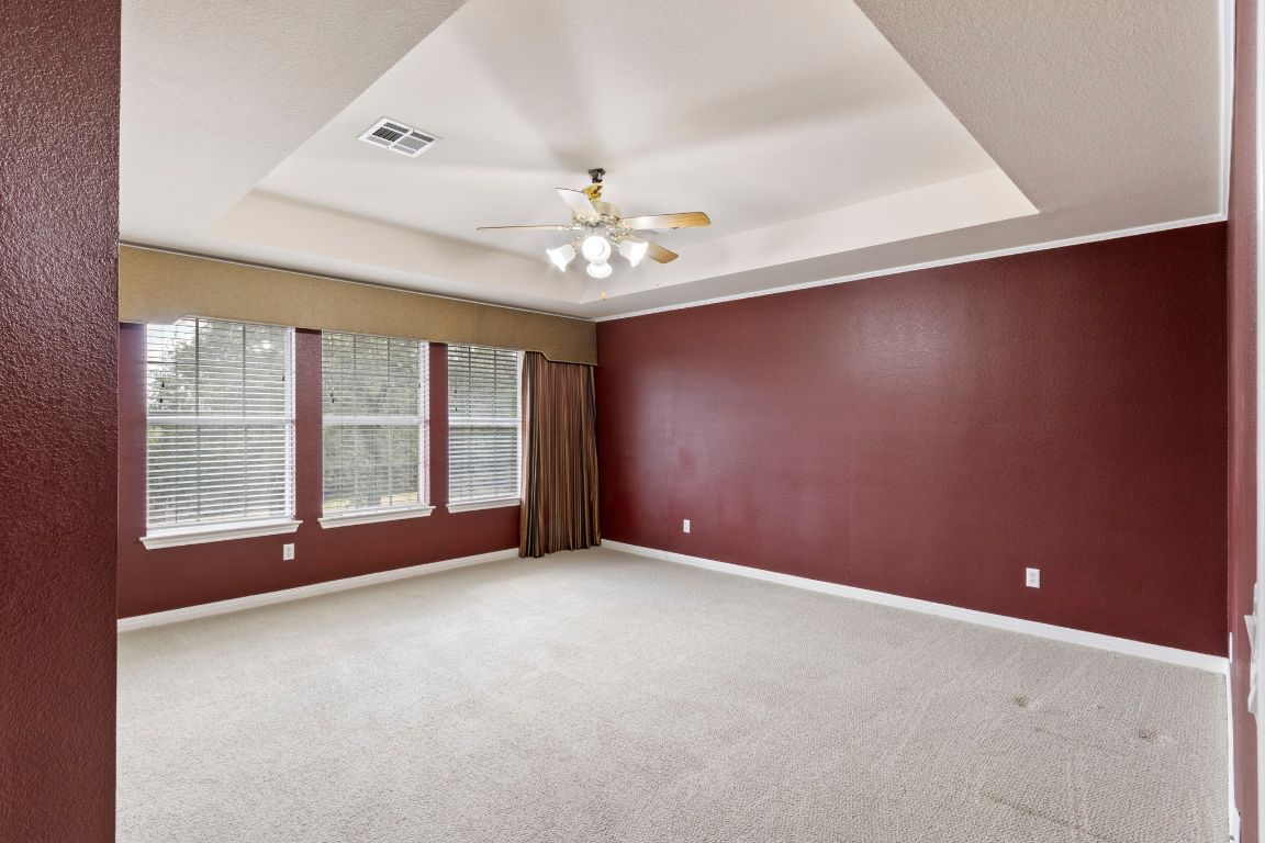 9501 Aire Libre Drive Austin, TX 78726 - Photo 23 of 38 an empty room with windows and chandelier fan