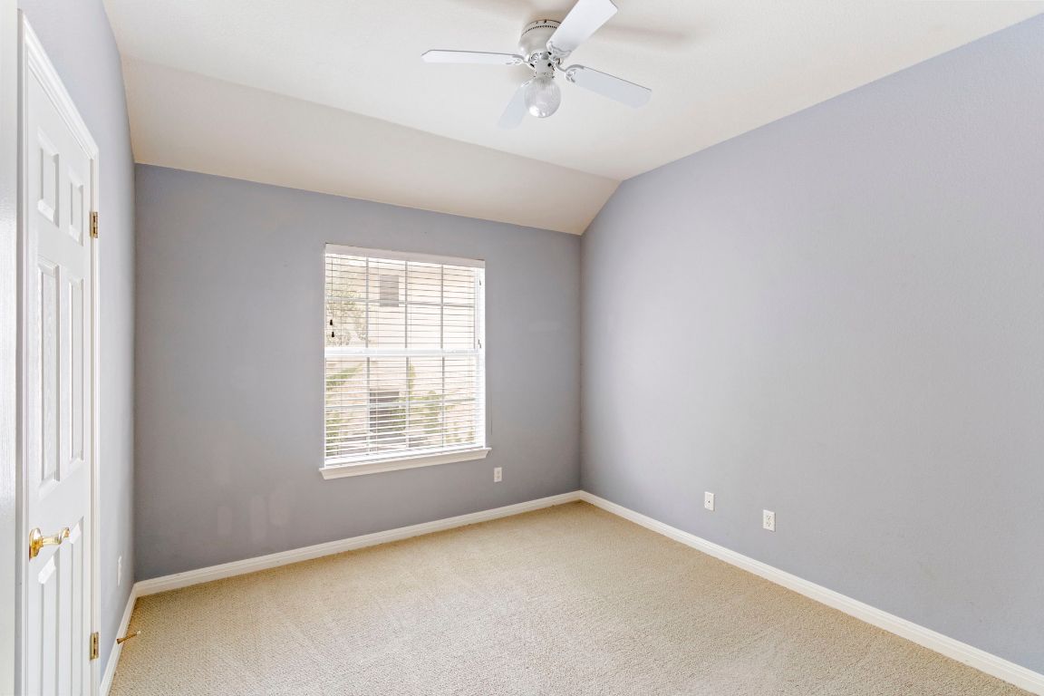 9501 Aire Libre Drive Austin, TX 78726 - Photo 29 of 38 an empty room with a window and ceiling fan