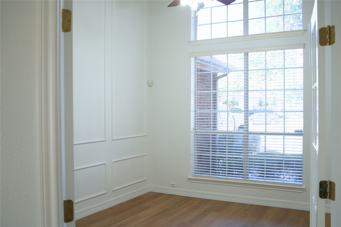 9501 Aire Libre Drive Austin, TX 78726 - Photo 9 of 38 a view of an empty room with wooden floor and a window