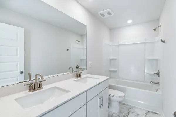 a bathroom with a sink toilet tub and shower