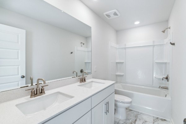 1037 Ewell Farm Drive Spring Hill, TN 37174 - Photo 13 of 31 a bathroom with a sink toilet tub and shower