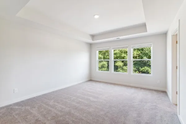 an empty room with large windows