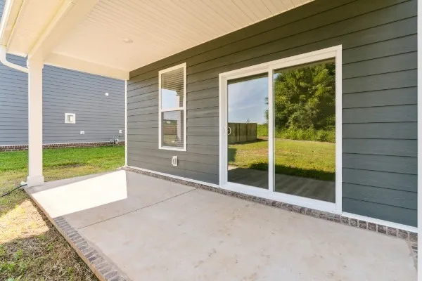 a view of a porch with wooden floor and backyard