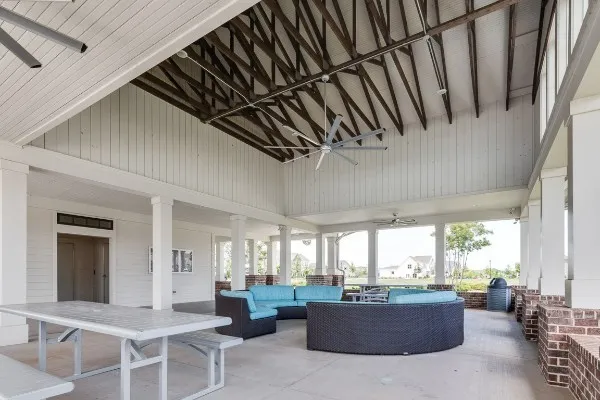 a living room with fireplace furniture and a large window