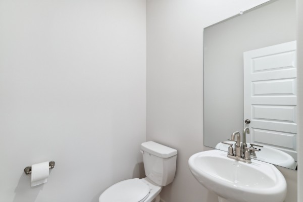 1037 Ewell Farm Drive Spring Hill, TN 37174 - Photo 5 of 31 a bathroom with a toilet a sink and mirror