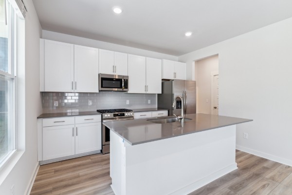 1037 Ewell Farm Drive Spring Hill, TN 37174 - Photo 8 of 31 a kitchen with stainless steel appliances granite countertop a stove a sink and a refrigerator