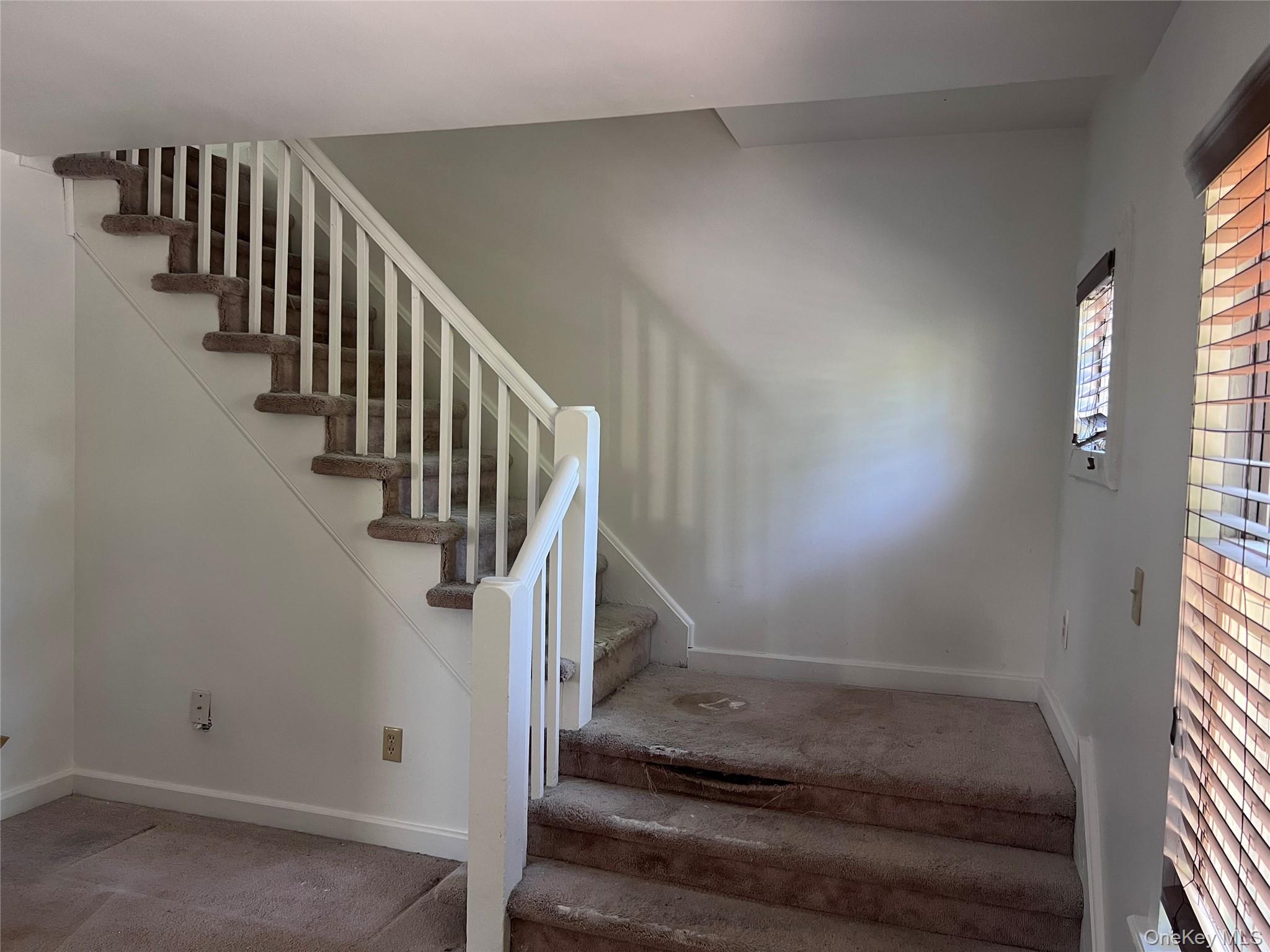 7 Berry Street Wallkill, NY 12589 - Photo 6 of 17 Carpeted staircase featuring white balusters and a wood handrail