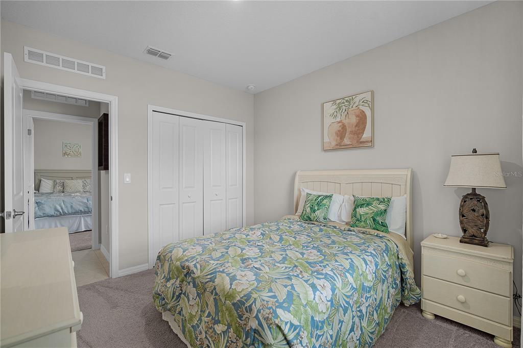 418 Fleming Street Sebastian, FL 32958 - Photo 25 of 38 a bedroom with a large bed and a chandelier
