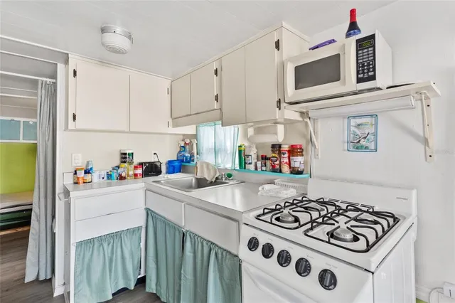 a kitchen with a stove a sink and a refrigerator