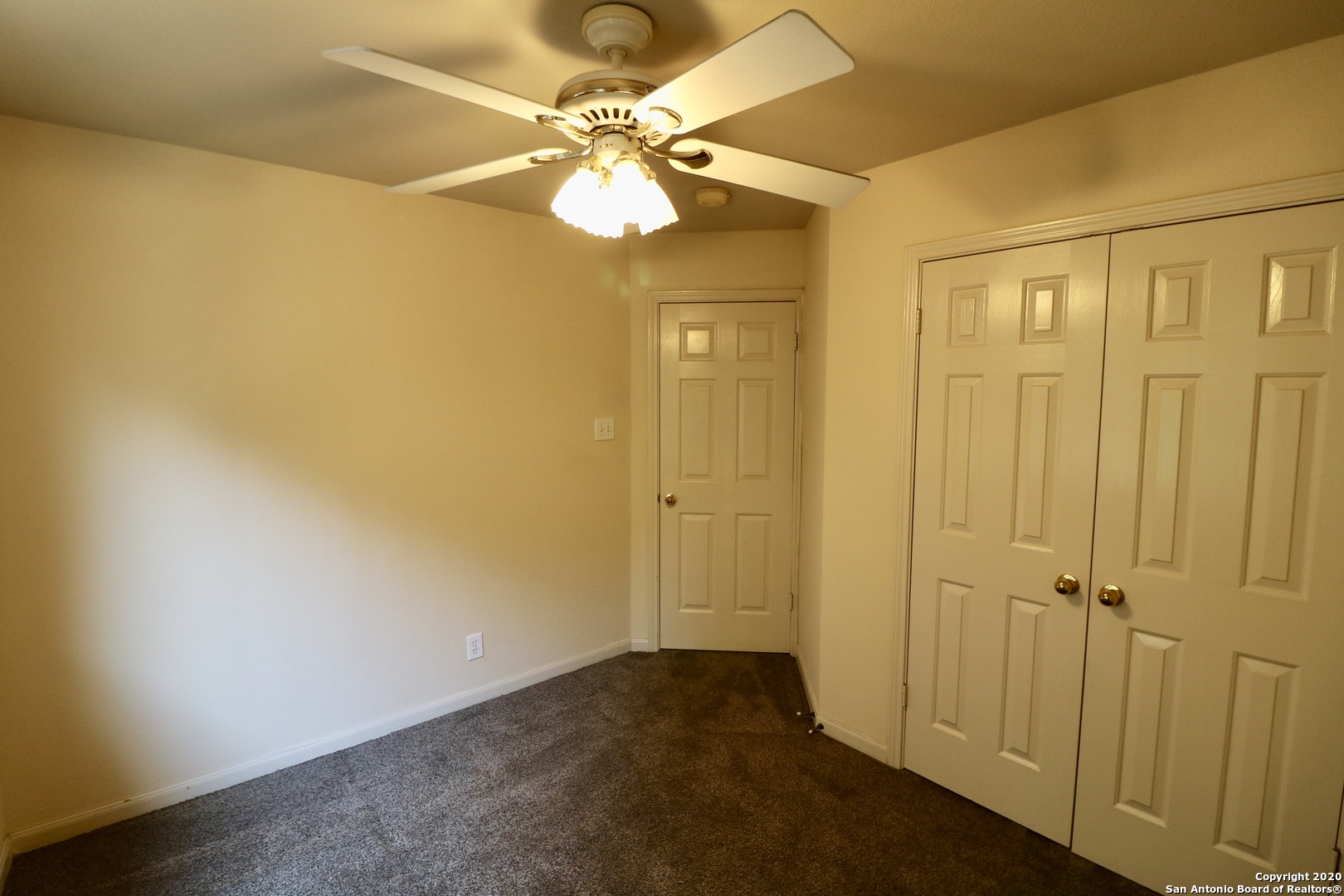 7 Claybrook San Antonio, TX 78254 - Photo 20 of 21 an empty room with a chandelier fan and wooden floor