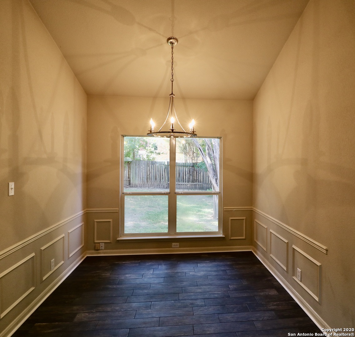 7 Claybrook San Antonio, TX 78254 - Photo 6 of 21 a view of an empty room with wooden floor and a window