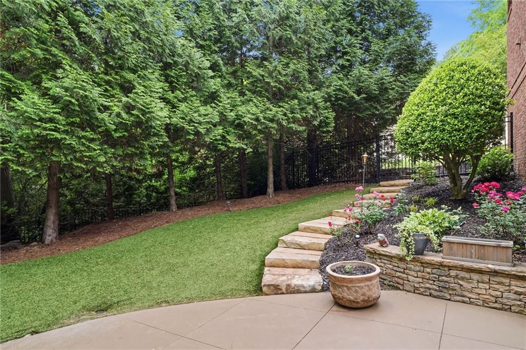 8340 Colonial Place Duluth, GA 30097 - Photo 57 of 74 a view of a back yard with a patio