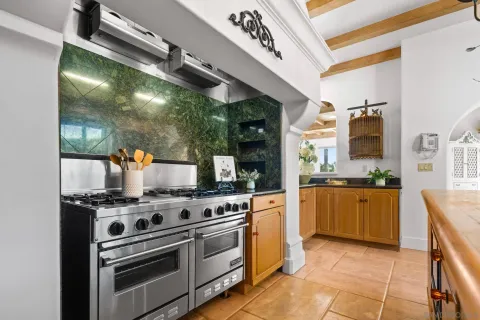 a kitchen with stainless steel appliances granite countertop a stove and a sink