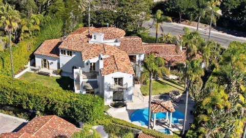 an aerial view of multiple houses with a yard