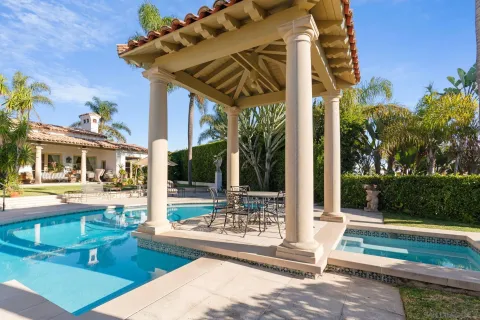 a view of a patio with table and chairs potted plants with wooden floor and fence
